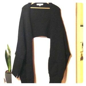 Black shawl with zipper sleeves.